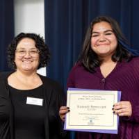 Two women posing with a certificate